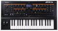 Top view of a Roland synthesizer keyboard with various knobs, buttons, faders, two wheel controllers, and a small display screen.