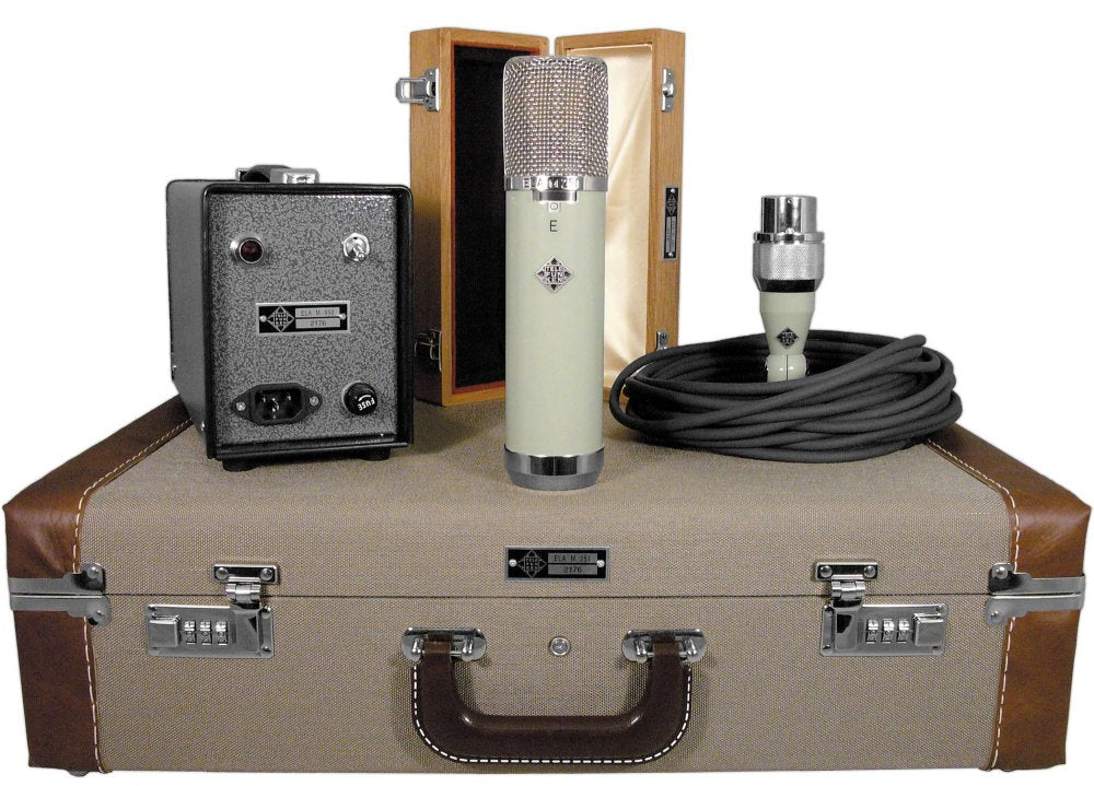 Microphone with power supply, cable, wooden storage box, and carrying case displayed on a surface.