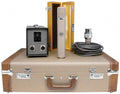 Microphone with power supply, cable, wooden case, and carrying case set on a white background.