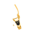 Gold colored metal tremolo arm assembly with black label and three screws on a white background.