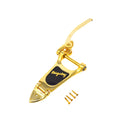 Gold metal vibrato tailpiece with black logo plate and four gold screws on white background.