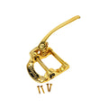 Gold-colored vibrato tailpiece with lever and Bigsby branding, shown with four screws on a white background.