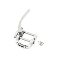 Polished metal vibrato tailpiece with lever and four screws on white background.