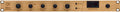 Front panel of a wooden rackmount audio compressor with knobs, buttons, and a VU meter display.