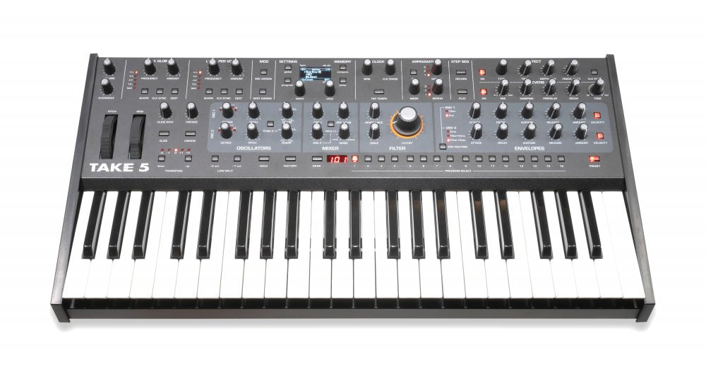 Front view of a TAKE 5 synthesizer with keyboard, knobs, sliders, buttons, and digital display on black panel.