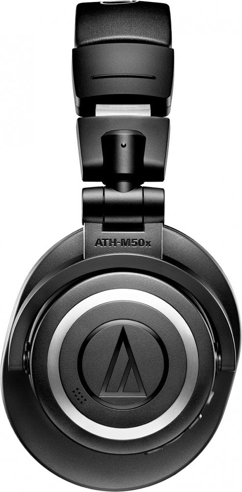Close-up view of the right earcup of black headphones showing ATH-M50x branding and a logo.