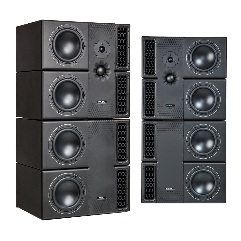 Four black studio monitors with PMC logo stacked on the left and three subwoofers stacked on the right.