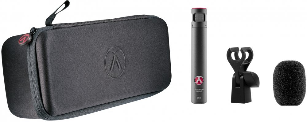 Microphone kit including carrying case, cylindrical microphone, clip mount, and foam windshield shown on white background.