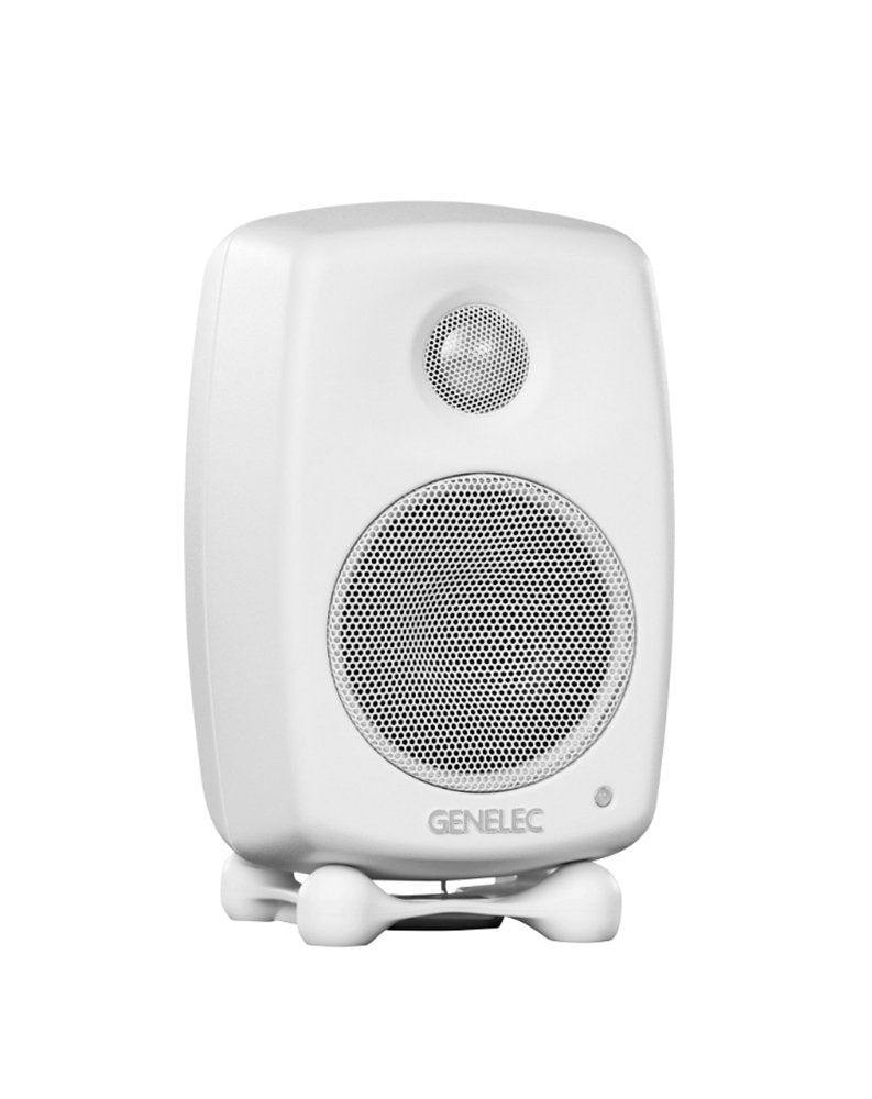 White GENELEC speaker with metal grilles on front woofer and tweeter, on a small white stand.