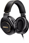 Black over-ear headphones with padded earcups and headband, featuring gold accents and SHURE branding.