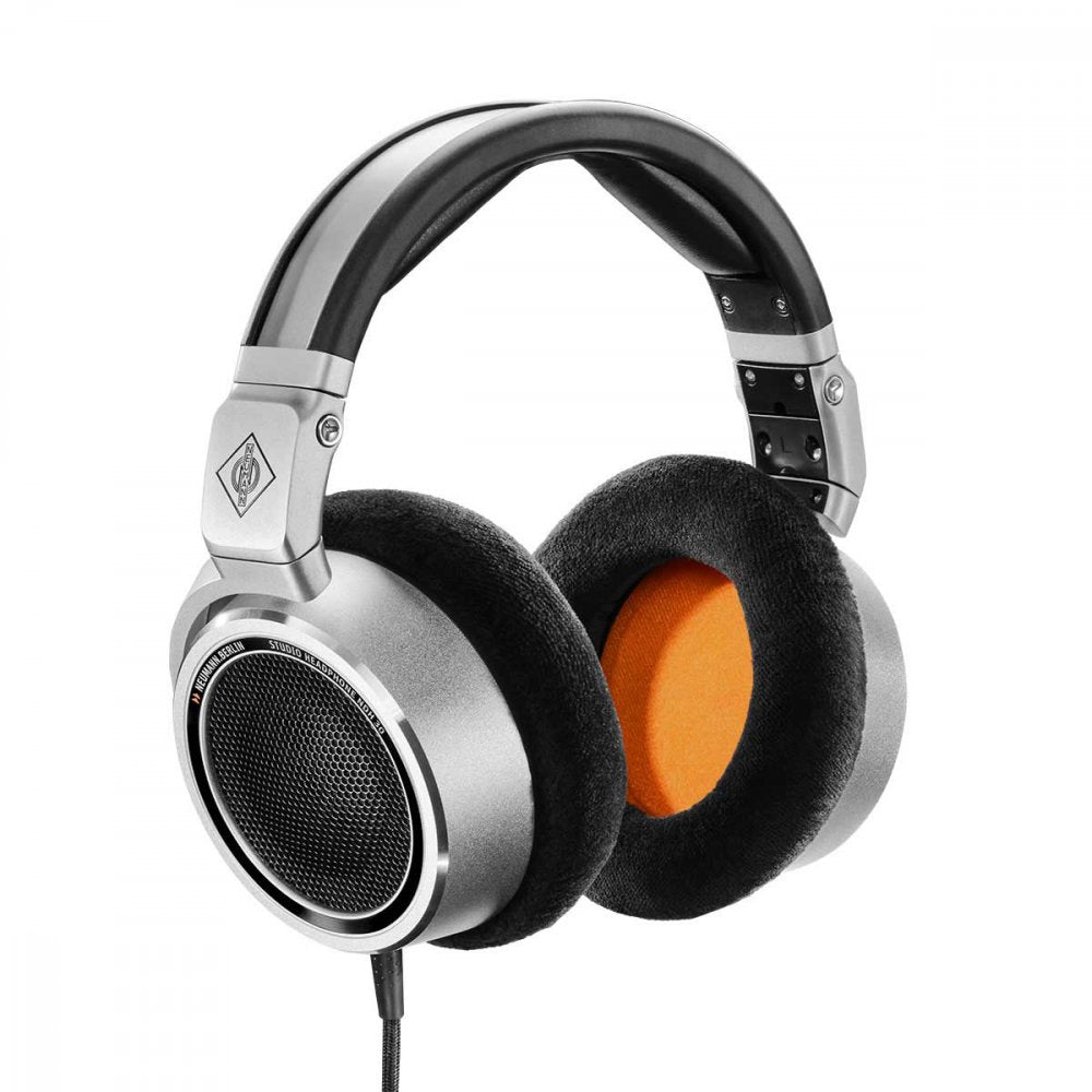 Close-up of over-ear wired headphones with black and silver design and orange inner ear cushions.