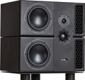 Black PMC studio monitor speaker with two large woofers and two honeycomb-patterned ports, shown stacked.