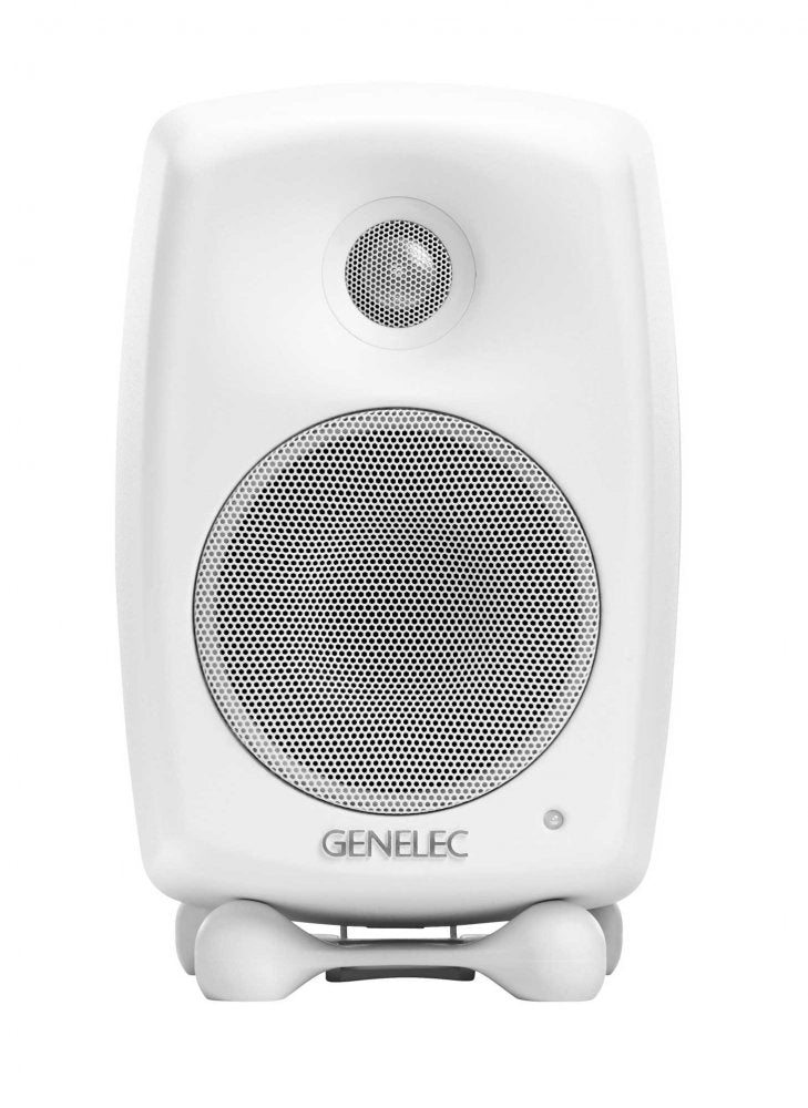 Front view of a white active speaker with two speaker grills and a stand beneath it.