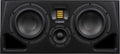 Front view of a black speaker with two large woofers, a small tweeter, and a yellow ribbon tweeter between them.
