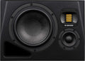 Black studio monitor speaker showing three drivers and a bass reflex port on the front panel.