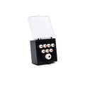 Clear-lidded black plastic box containing a set of small white round pieces with red centers arranged in rows.