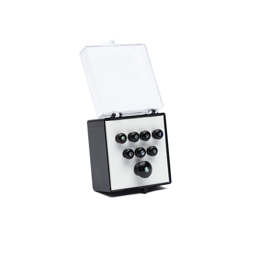 Set of black bridge pins with pearl inlays displayed in a small black and white plastic box with a clear lid.