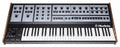 Black and gray synthesizer keyboard with wooden side panels, multiple controls, and 37 keys.