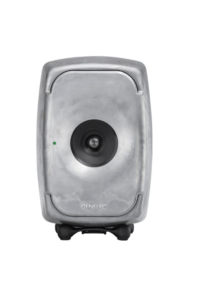 Front view of a gray Genelec speaker with a single centered driver and a green indicator light on the left.