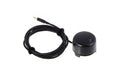 Black circular device connected to a black coiled cable with a 3.5mm audio jack plug