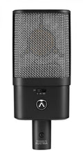 Black condenser studio microphone with a mesh grille, control switch, and XLR connector, designed in Austria.