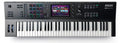 Top view of AKAI MPC Key 61 keyboard with pads, knobs, buttons, and touchscreen display showing software interface.