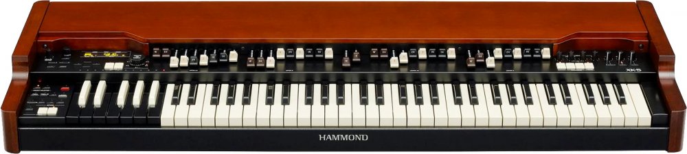 Keyboard synthesizer with two manuals, multiple control switches, and wooden side panels under a brown finish.