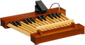 Wooden 25-note pedal board with expression pedal and attached cable on a white background.