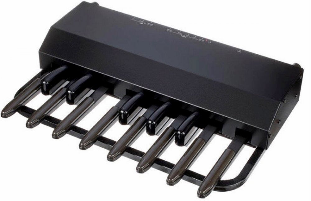 Black foot pedal controller with eight black pedals and multiple switches on top in a curved metal frame.
