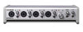 Silver audio interface with four combo inputs, gain controls, monitor and headphone outputs.