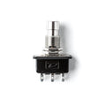 Metal push button switch with black plastic base and three metal terminal pins, marked with a letter D on the base.
