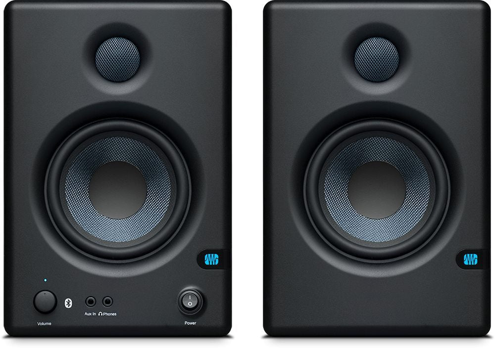 Front view of a pair of black studio monitor speakers with visible drivers, volume knob, power switch, and audio input jacks.