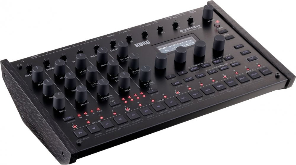 Black KORG Drumlogue drum machine with multiple knobs, buttons, LED indicators, and wood side panels.