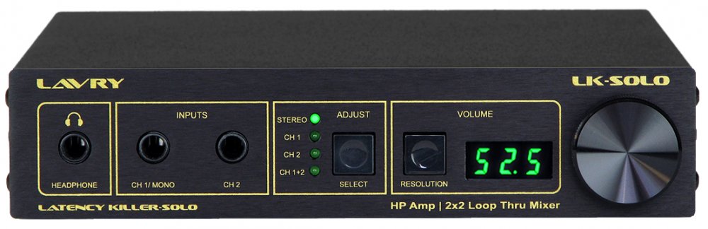 Front panel of black audio monitor controller with headphone jack, inputs, adjust button, volume display, and large knob.