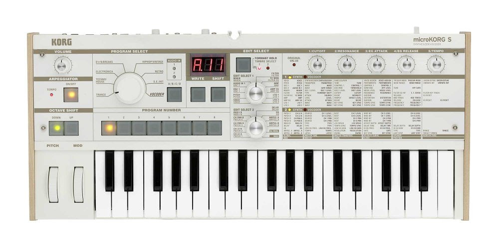 Top-down view of a white KORG microKORG S synthesizer keyboard with various knobs, buttons, and a small display screen.