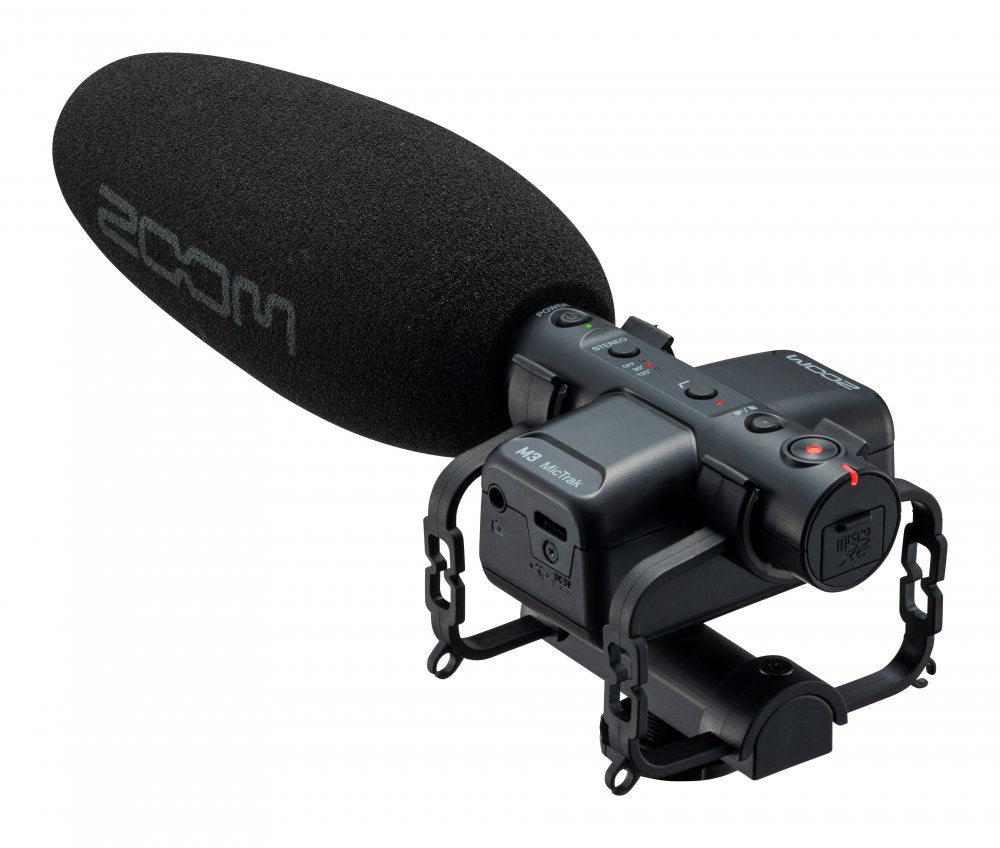 Black handheld microphone with foam windscreen, shock mount, and visible controls including power, stereo switch, and record button.