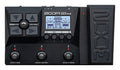 Black Zoom G2X Four multi-effects pedal with LCD display, knobs, footswitches, and directional buttons.