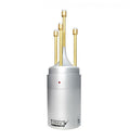 Silver cylindrical audio device with four vertical gold rods and a small red indicator light on the front.