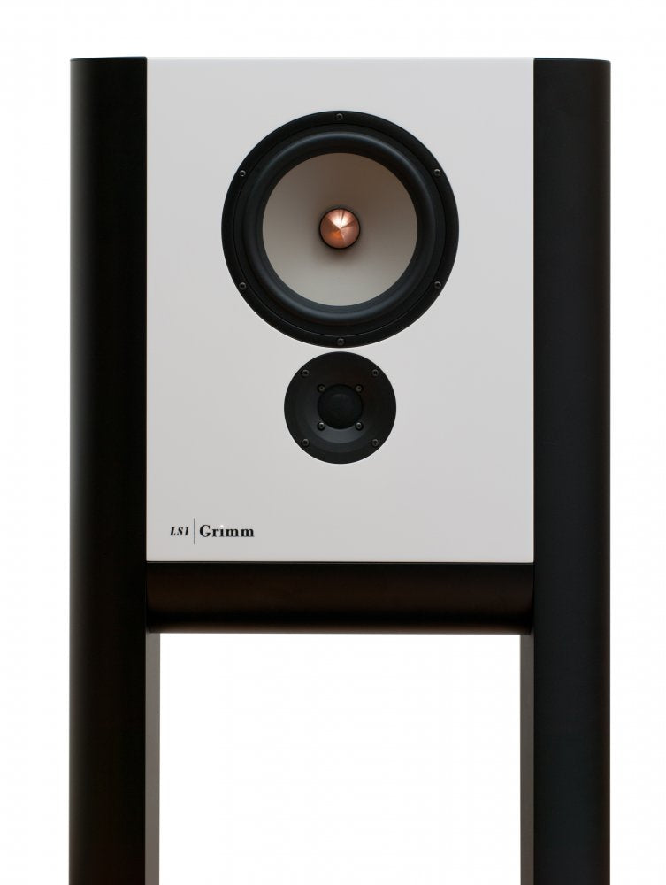A tall, slim white lacquer Grimm Audio LS1v2 active loudspeaker, its narrow rectangular cabinet suspended between two curved half-cylinder legs that form an integrated floor stand.