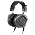 Open-back over-ear headphones with black ear cushions, metal frame, and visible audio cables connected.