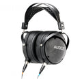 Black over-ear headphones with padded leather ear cups and headband, labeled AUDEZE, with two cables connected.
