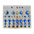 Front panel of a stereo microsound processor module with multiple knobs, switches, jacks, and buttons labeled in blue on a silver metal surface.