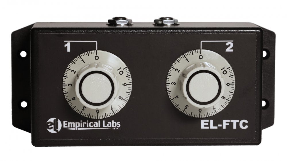 Black rectangular audio device with two numbered white rotary knobs and two 1/4 inch jacks on top.