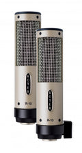 Two beige and black cylindrical ROYER R-10 microphones with metal mesh grilles are shown side by side.