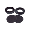 Two black fabric ear pads and two round foam inserts for headphones on a white background.