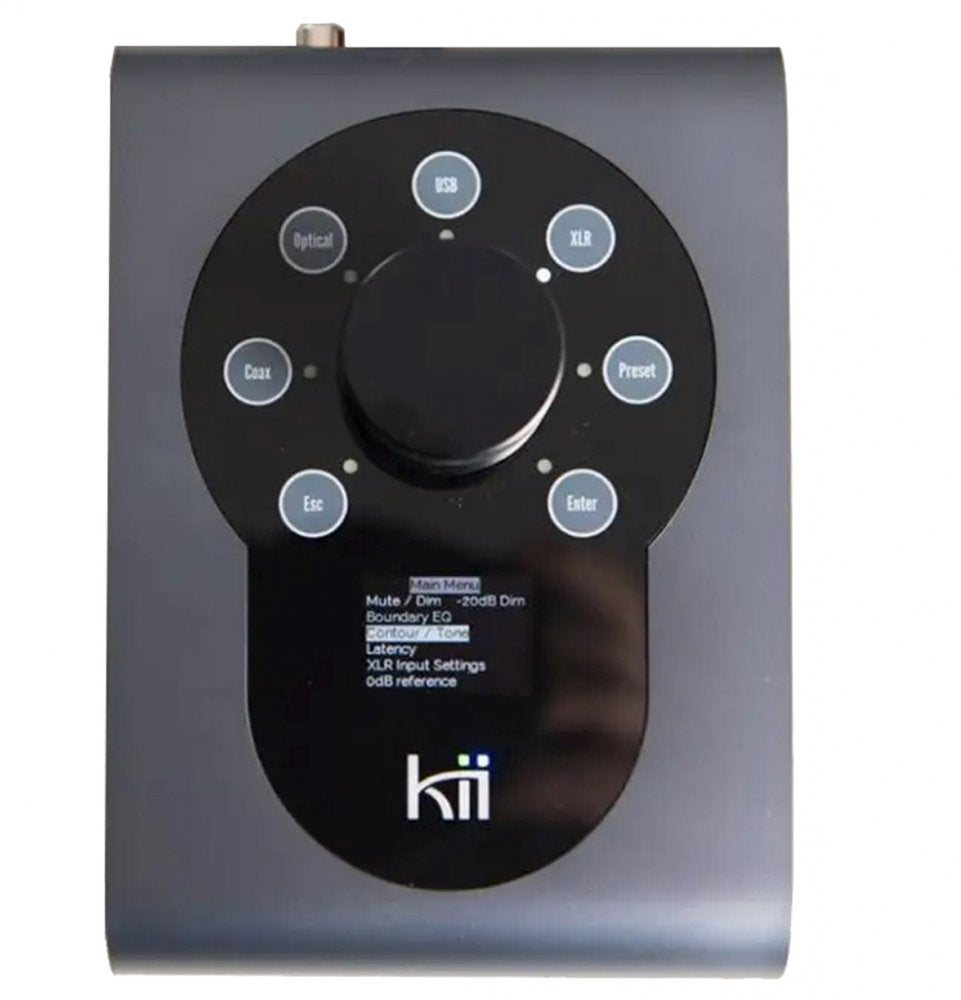 Anodized dark grey device with a large rotary knob surrounded by labeled buttons and a small screen above the logo kii.