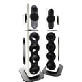 Pair of tall white and black studio monitor speakers with multiple driver cones and side ports on black stands.