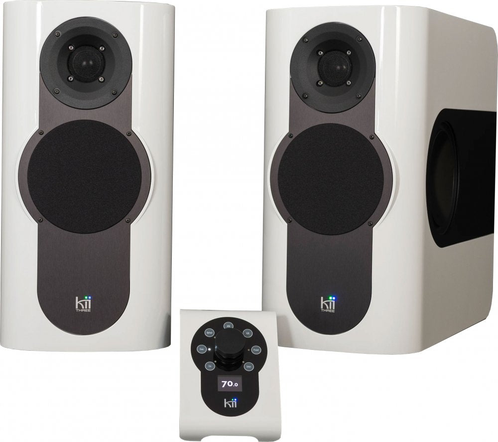 Pair of white studio monitor speakers with black front panels and a matching control unit showing volume 70.0