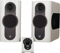 Pair of white studio monitor speakers with black front panels and a matching control unit showing volume 70.0