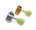 Two vintage-style guitar machine heads, one gold and one silver, with green plastic tuning pegs.